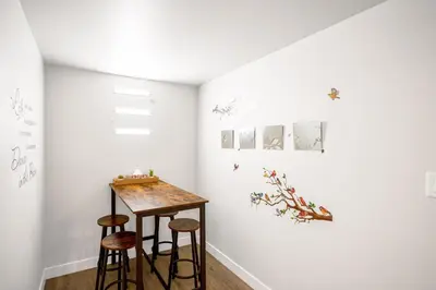 a room with two stools and a table on a wall at New 2BD Suite Near Events Center in Langley