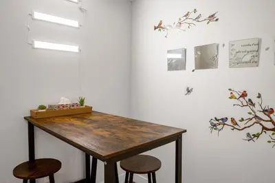 a room with a wooden table and two stools at New 2BD Suite Near Events Center in Langley