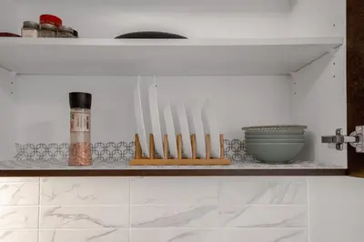 a shelf with a bunch of knives and a bowl at New 2BD Suite Near Events Center in Langley