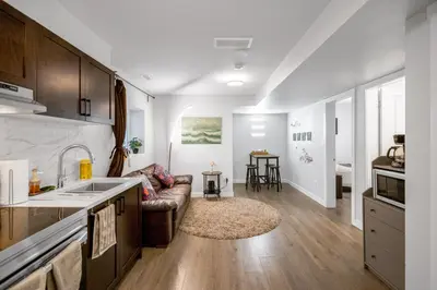 a kitchen and a living room with a couch at New 2BD Suite Near Events Center in Langley
