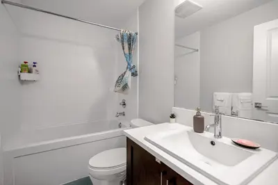a bathroom with a sink and a toilet and a tub at New 2BD Suite Near Events Center in Langley