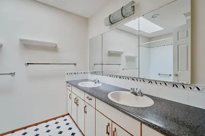 a bathroom with two sinks and a large mirror at The Coastal Garden Retreat in Delta