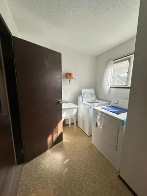 a laundry room with a washer and dryer at Beautiful home near City centre! in Kitimat