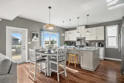 a kitchen and dining room with a table and chairs at Luxe & Lake 6BR Getaway Hot Tub Near the Lake in Sylvan Lake