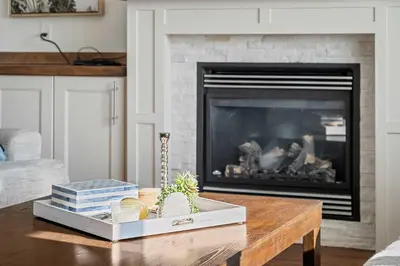 a living room with a fireplace and a coffee table at Luxe & Lake 6BR Getaway Hot Tub Near the Lake in Sylvan Lake