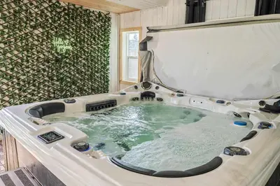 a large bath tub in a room at Luxe & Lake 6BR Getaway Hot Tub Near the Lake in Sylvan Lake