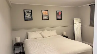 a bedroom with a bed with four pictures on the wall at Supinder's Rentals in Golden