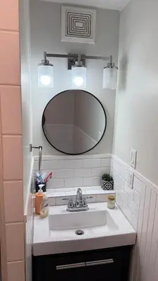 a bathroom with a sink and a mirror at Supinder's Rentals in Golden
