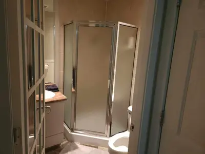a bathroom with a shower and a toilet at Central Townhouse Richards Street in Vancouver