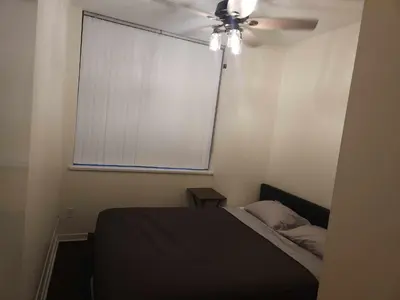 a bedroom with a bed and a ceiling fan at Central Townhouse Richards Street in Vancouver