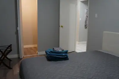 a bedroom with a bed with blue towels on it at YYC : 2-Bedroom City Apartment in Calgary