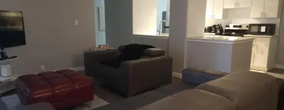 a living room with a couch and a chair at YYC : 2-Bedroom City Apartment in Calgary