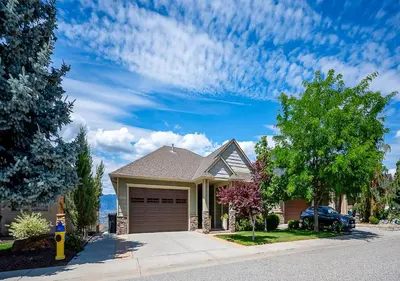 a house with a parking meter in front of it at Full House with Amazing Okanagan Views and Hot Tub in Kelowna