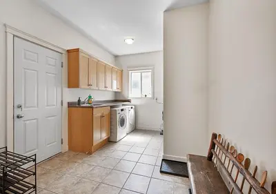 a kitchen with a washer and dryer in it at Full House with Amazing Okanagan Views and Hot Tub in Kelowna