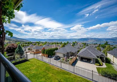 arial view of a house with a fence at Full House with Amazing Okanagan Views and Hot Tub in Kelowna