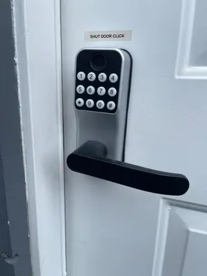 a remote control sticking out of a door at Budget friendly 2-Bed 1-Bath Suite in New Westminster