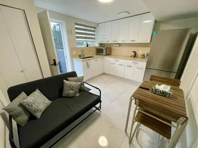 a living room with a couch and a table at Budget friendly 2-Bed 1-Bath Suite in New Westminster