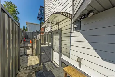 a porch of a house with a door and a bench at Budget friendly 2-Bed 1-Bath Suite in New Westminster