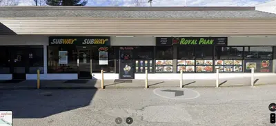 a store with signs in the front of a street at 4 Bedroom Semi-basement Suite in Burnaby Metrotown in Burnaby