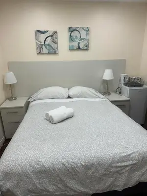 a white bed with two towels on top of it at Dunbar Guest Home close downtown Vancouver, UBC and store in Vancouver