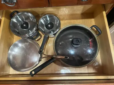 four pots and pans in a wooden box at Dunbar Guest Home close downtown Vancouver, UBC and store in Vancouver