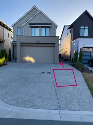 a house with a garage with a red arrow at Oceanside 2 Bedroom Suite in Royal Bay-Free Nespresso Coffee with Welcome Treats in Colwood