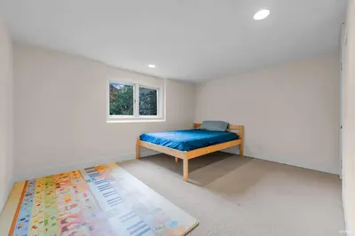 a bedroom with a bed and a window and a rug at Luxuary Stay in West Vancouver in West Vancouver