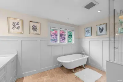 a white bathroom with a tub and a shower at Luxuary Stay in West Vancouver in West Vancouver