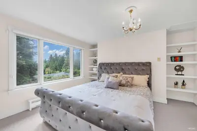 a bedroom with a large bed with a large window at Luxuary Stay in West Vancouver in West Vancouver