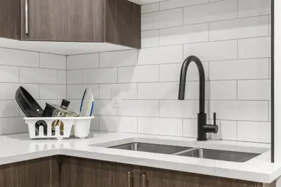 a kitchen with a sink and a counter top at Lake Community Hideout in Chestermere