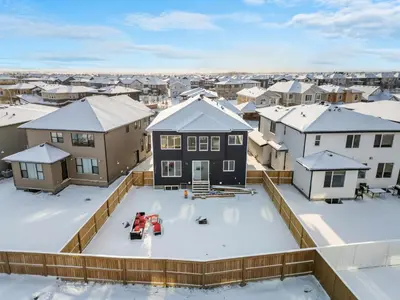 an aerial view of a snow covered neighborhood with houses at Lake Community Hideout in Chestermere
