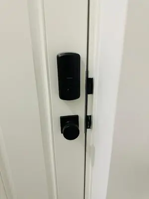a close up of a door with a black box at 2 Bedroom snug retreat in Livingston Calgary Alberta in Calgary