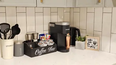 a kitchen counter with a coffeemaker and a coffee station at Modern Suite - Separate Entry - Self Check-In in Calgary