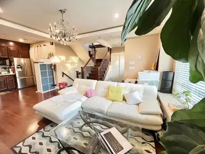 a living room with a white couch in a kitchen at Cozy stay in Cental Vancouver in Vancouver
