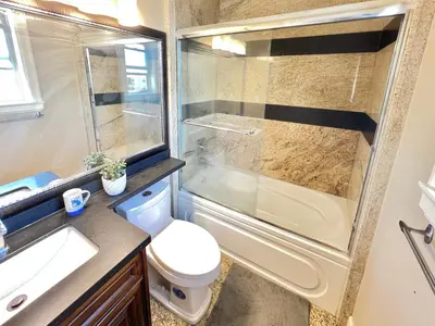 a bathroom with a shower and a toilet and a sink at Cozy stay in Cental Vancouver in Vancouver