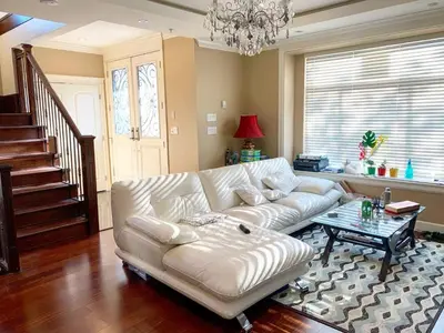 a living room with a white couch and a table at Cozy stay in Cental Vancouver in Vancouver
