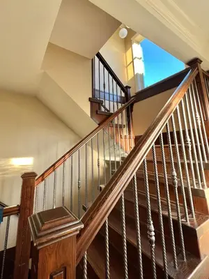 a staircase in a house with wooden railings at Cozy stay in Cental Vancouver in Vancouver