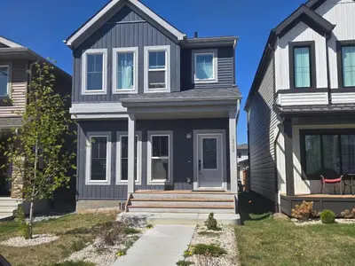 a house with a gray house at Bedroom with TV in Upland E in Edmonton