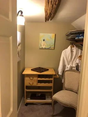 a room with a chair and a table and a desk at Country Cottage B&B in Vernon
