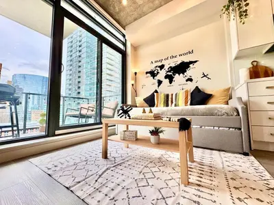 a living room with a couch and a table at Elegant, Comfy & Sophisticated MetroLux Downtown Suite in Calgary