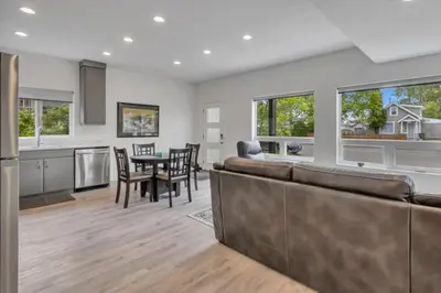 a kitchen and living room with a couch and a table at Pure Paradise in Prince George