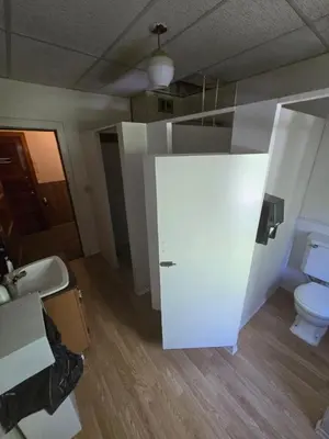 a white bathroom with a toilet and a sink at Coal Branch Hotel & Restaurant