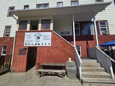 a building with a bench in front of it at Coal Branch Hotel & Restaurant