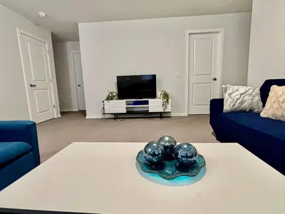 a living room with a couch and a tv at Zillion’s Joy in Calgary