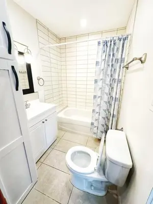 a bathroom with a toilet and a sink and a tub at 5 Min to Southgate Mall and U of A, Bright and Private, Cool Summer Stay in Edmonton
