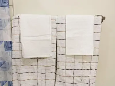 two towels hanging on a towel rack in a bathroom at 5 Min to Southgate Mall and U of A, Bright and Private, Cool Summer Stay in Edmonton