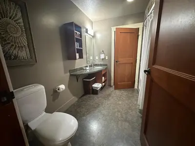 a bathroom with a toilet and a sink at Solara 2BR Retreat - Pool - Hot Tub & Resort Perks in Canmore