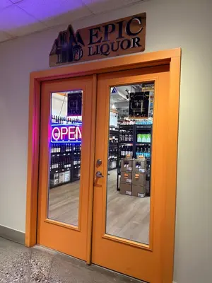 an orange door to a store with a sign above it at Solara 2BR Retreat - Pool - Hot Tub & Resort Perks in Canmore