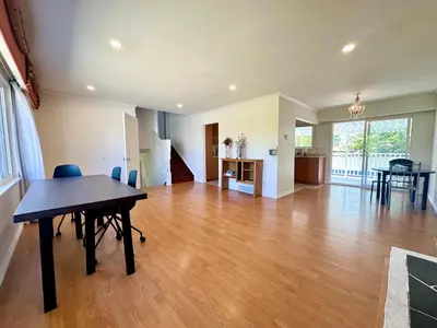 a large living room with a table and a kitchen at Beautiful Place with Kitchen, Washing Machine and Internet Near YVR Airport, Transit and Shopping Mall in Richmond