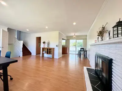 a living room with a fireplace and a dining room at 2 Bedrooms Garden Suite with Living Room, Kitchen and Laundry near YVR Airport, Transit and Shopping Mall in Richmond